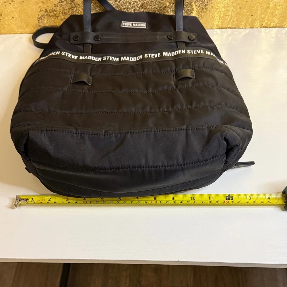 Steve Madden Bjodah Black Quilted Backpack with carry handles and branded strap